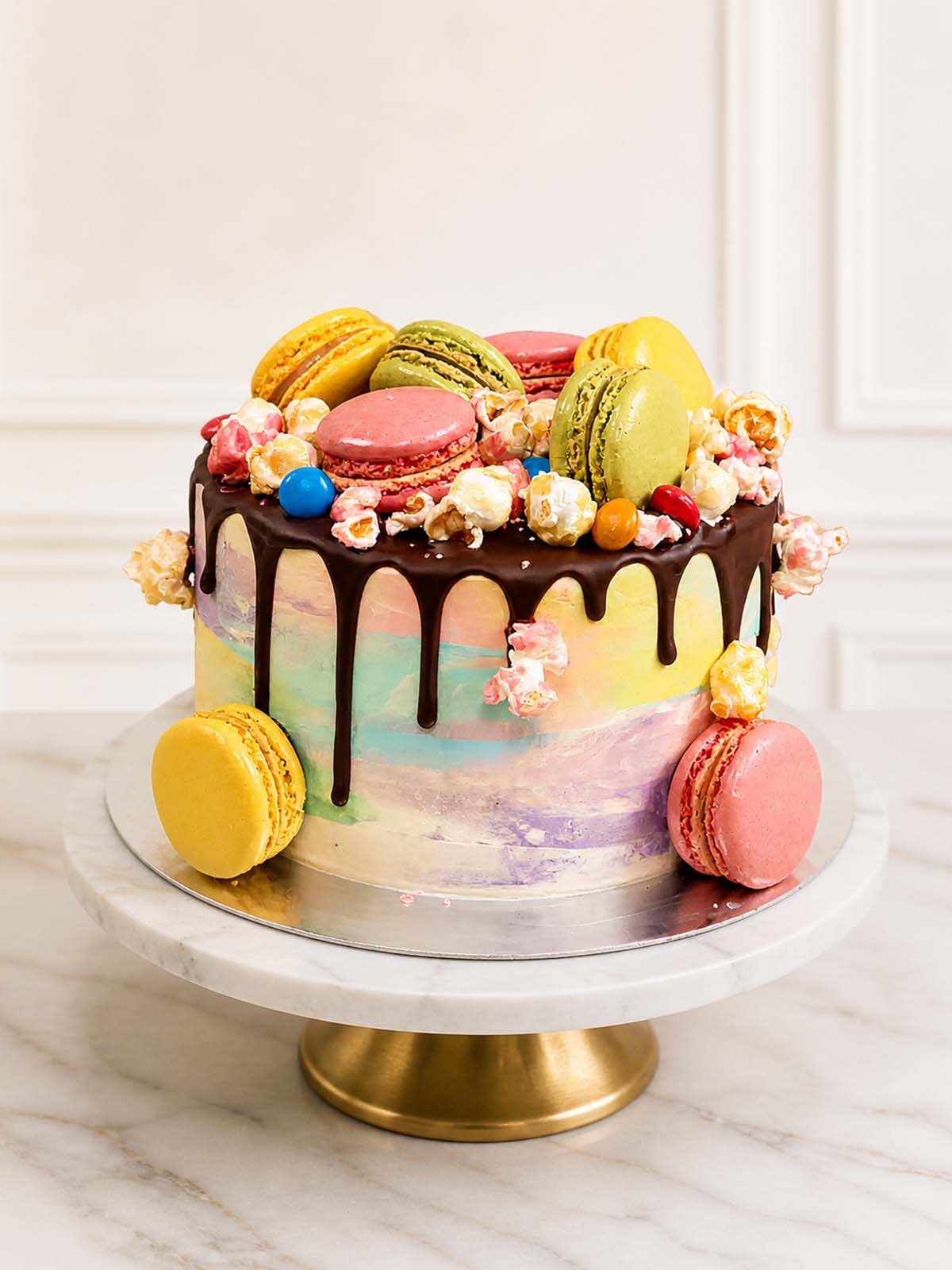 Luxury colourful vanilla cake with macarons and popcorn, London & Surrey.