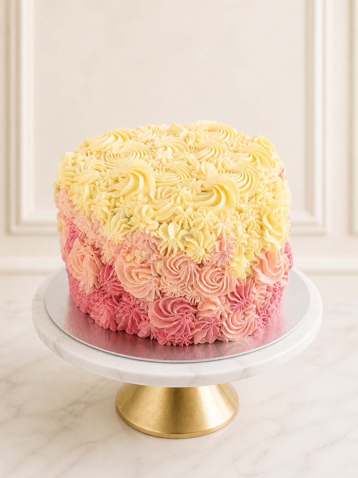 An elegant pink ombre heart-shaped cake featuring layers of rich red velvet sponge and artistically piped vanilla Swiss meringue buttercream, delivered in London and Surrey.