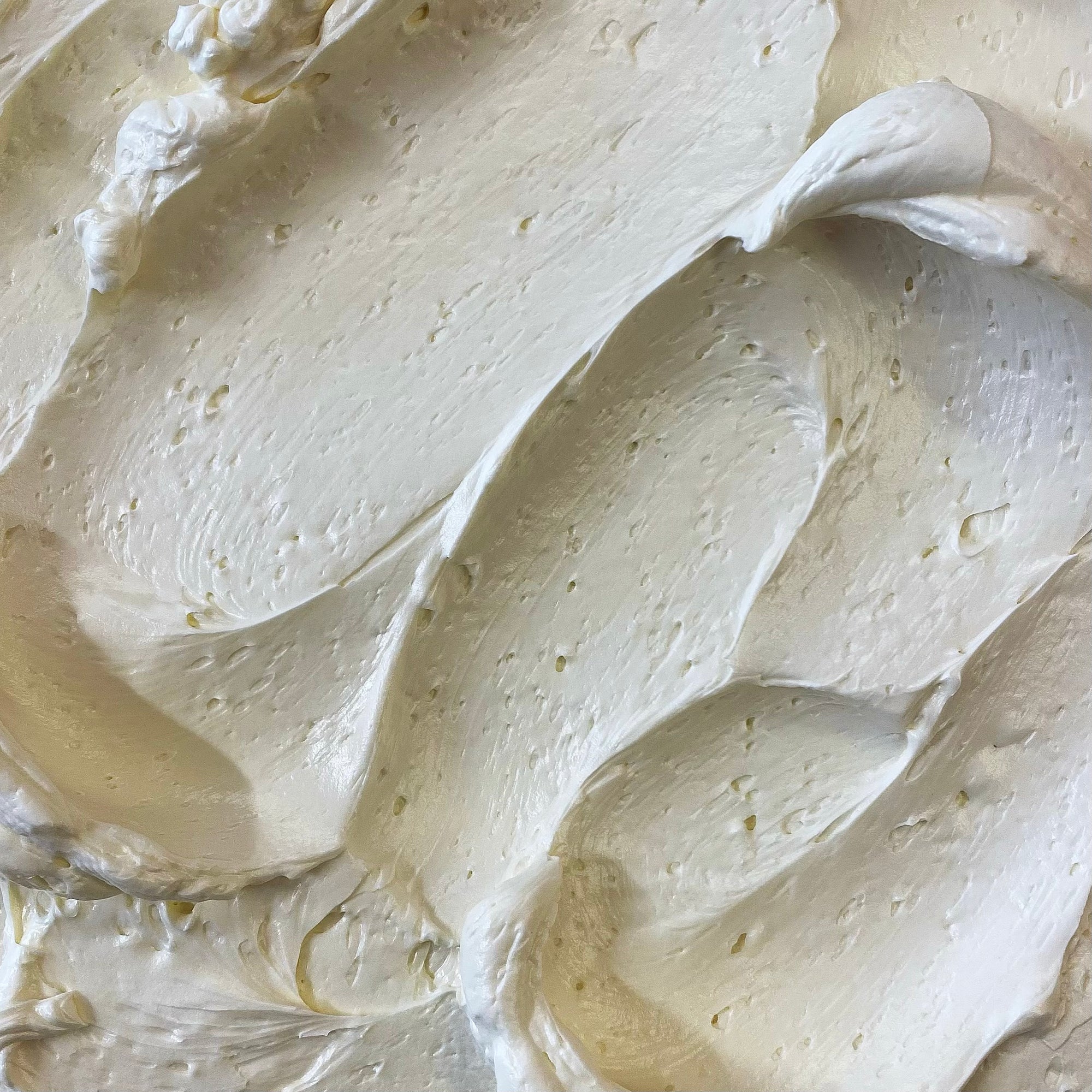 Swirls of white frosting with small air bubbles