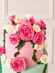 Pink and pastel green wedding cake decorated with pink and white roses handmade and delivered in London and Surrey. 