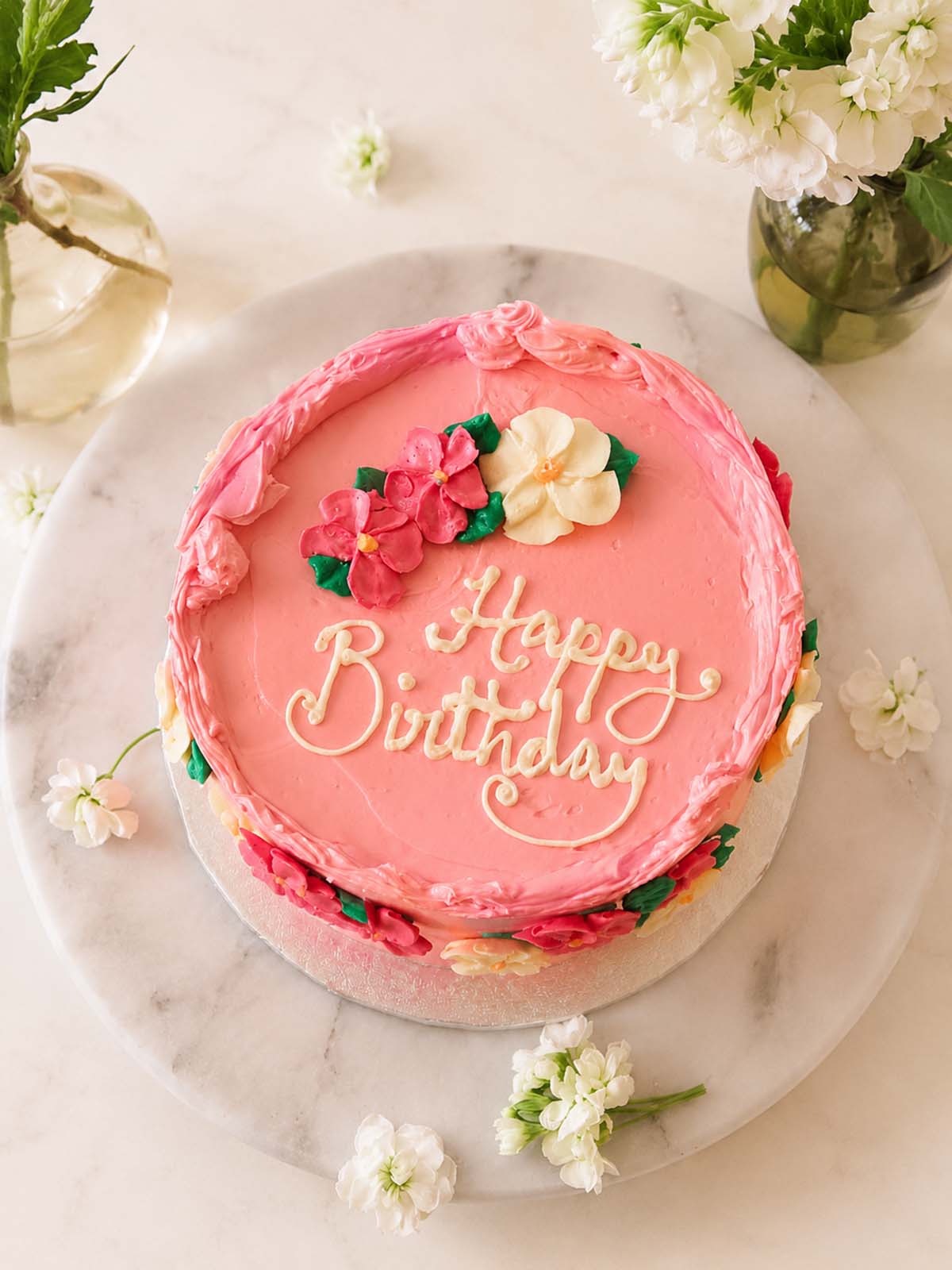 Pink birthday cake with floral decorations delivered in London (M25) and Surrey (UK(. 