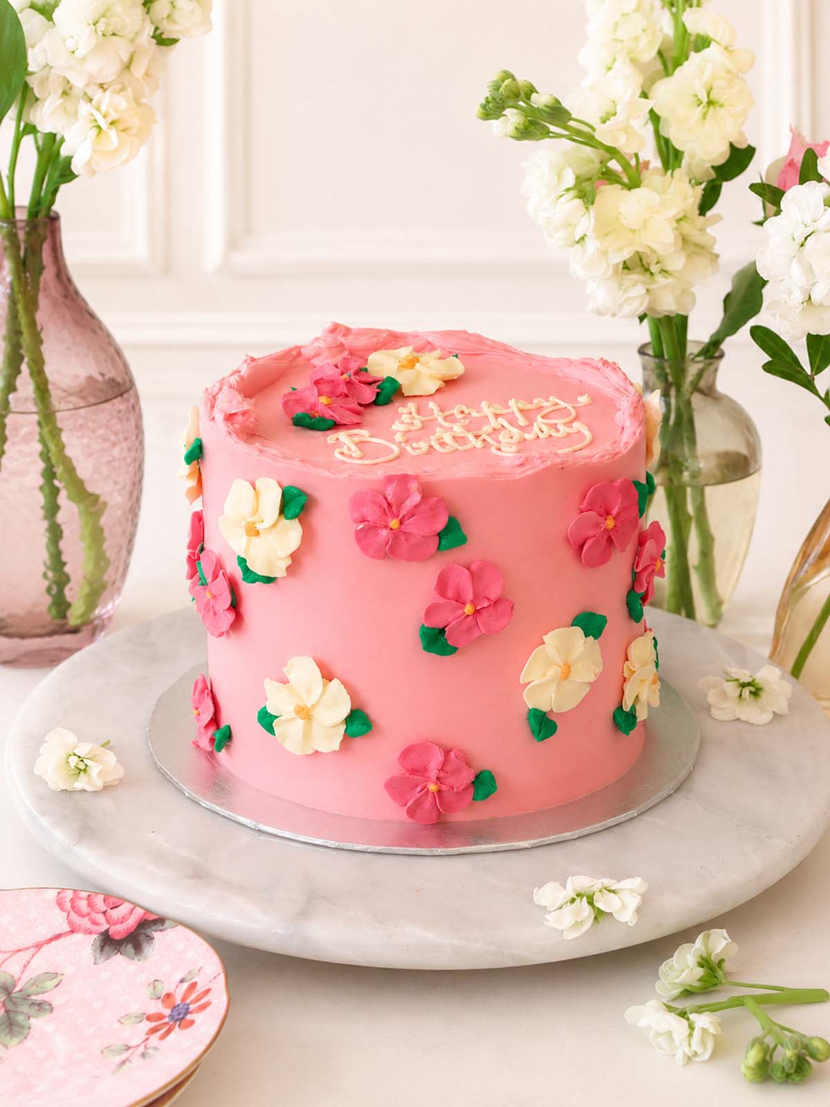 Pink celebration cake with floral decorations handmade to order for delivery in London and Surrey (UK).
