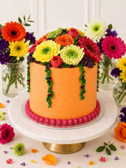 Peach buttercream cake with hand-piped gerberas, roses and blossoms