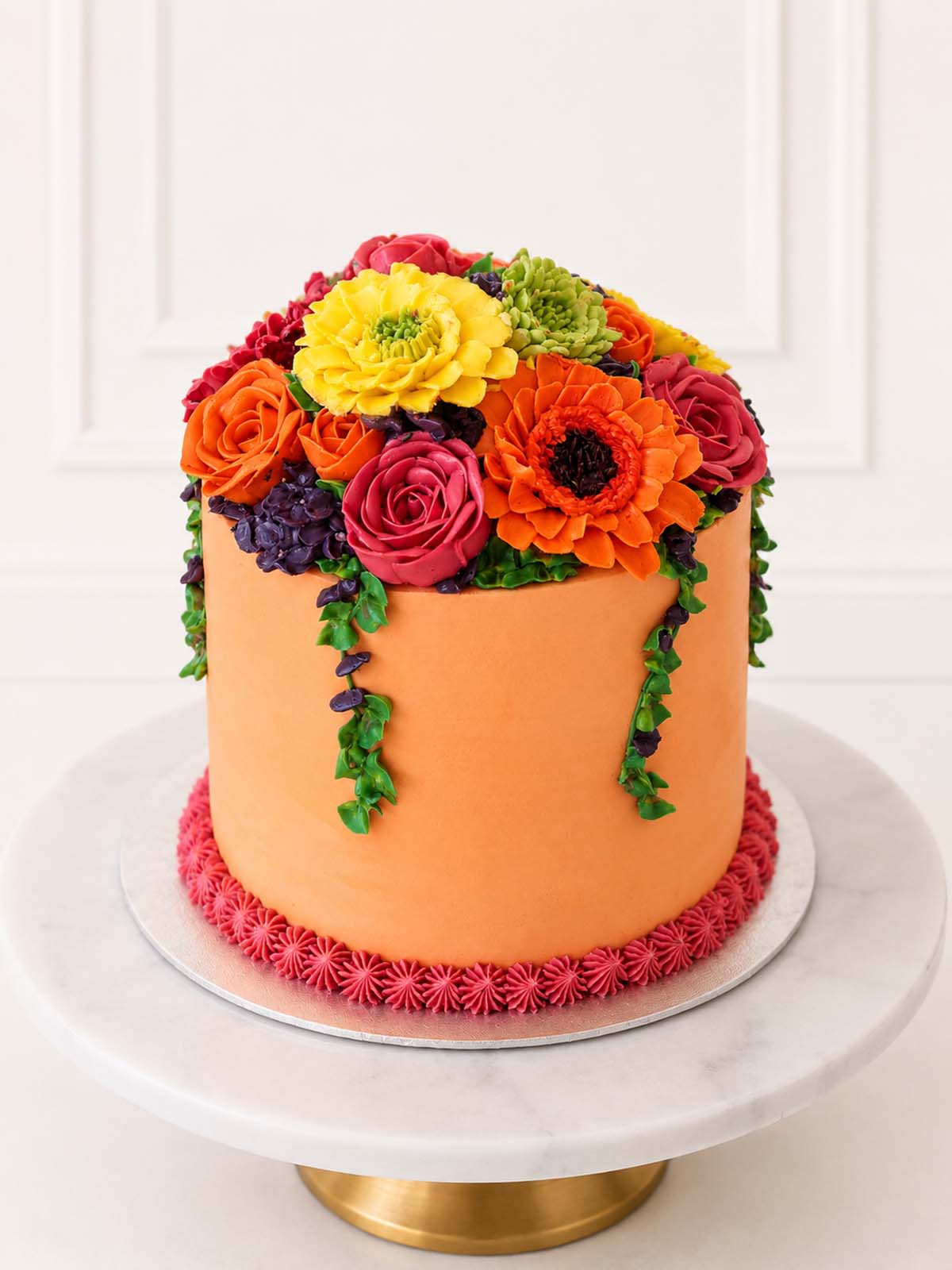 Bright Buttercream Bloom Cake on a white marble cake stand