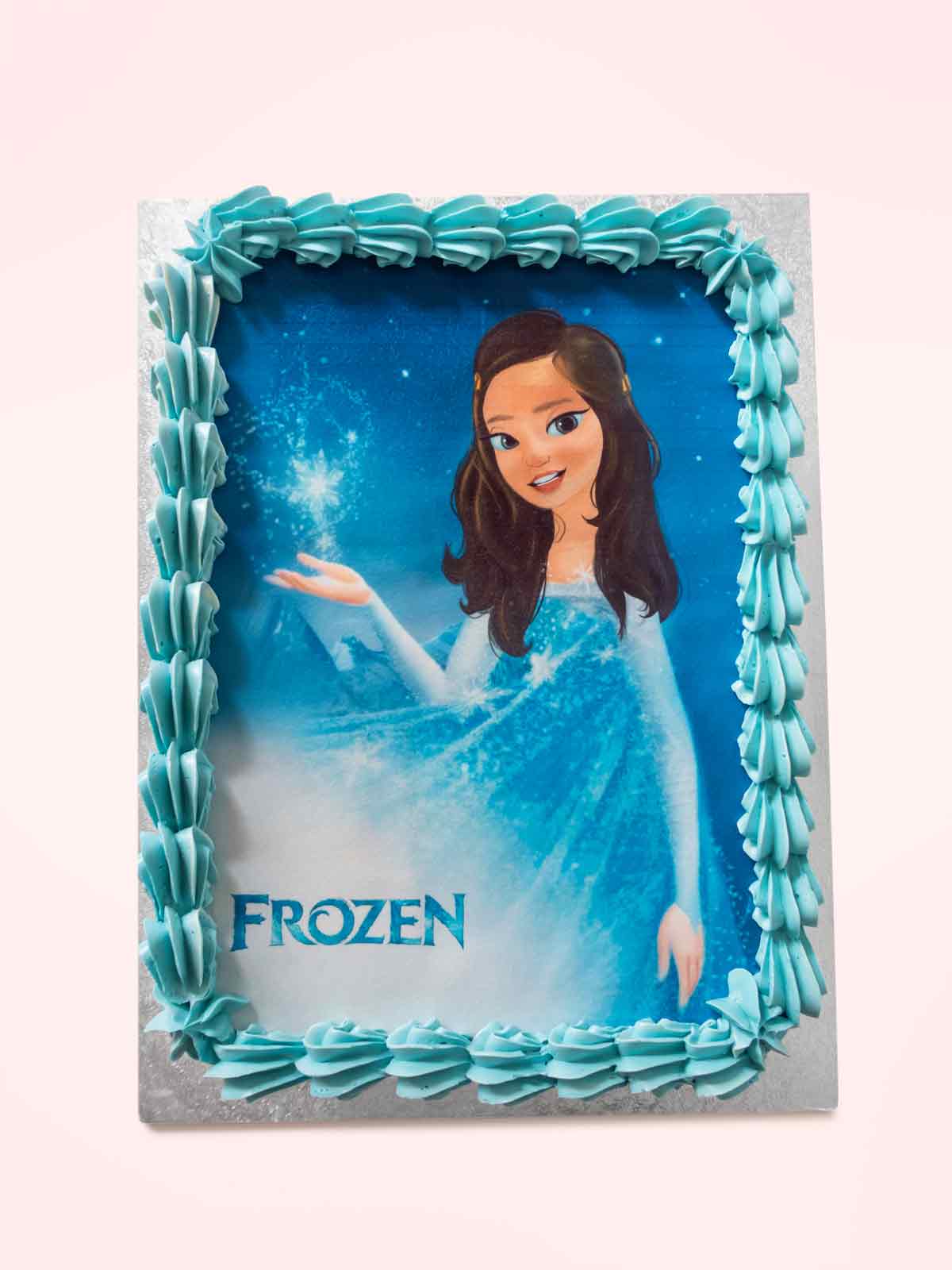 Frozen themed rectangular cake with a picture of Elsa and blue icing border