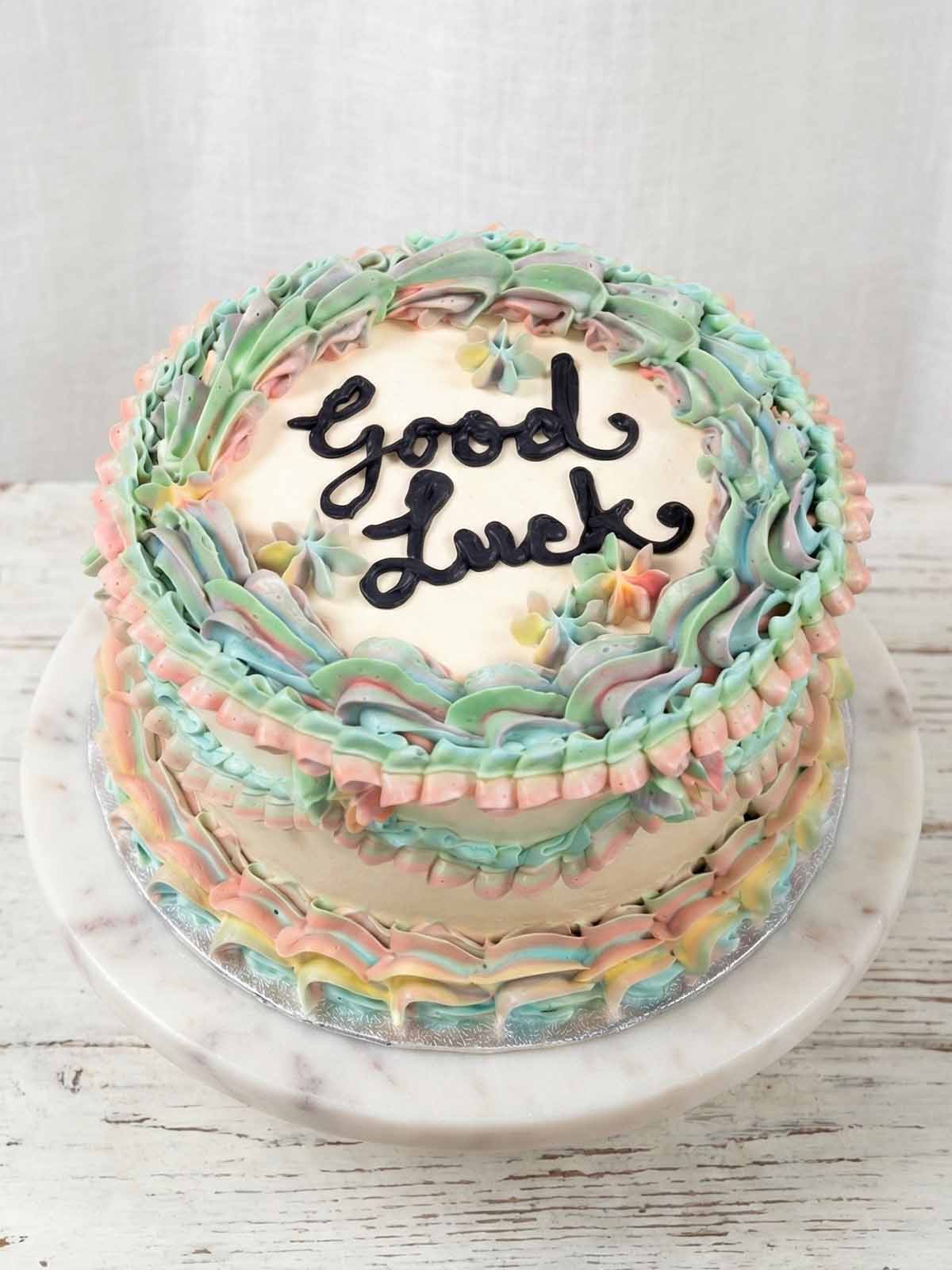 Good Luck cake with pastel rainbow ruffles