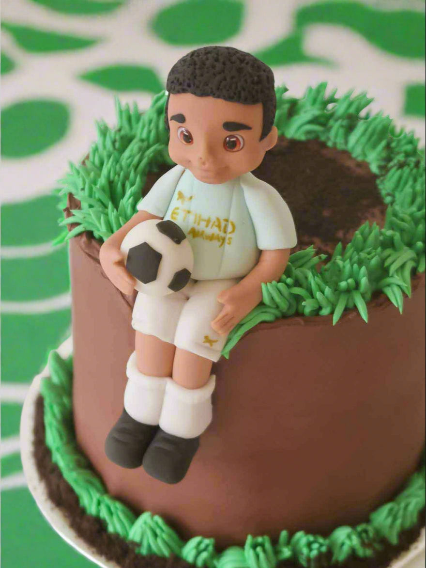 Custom footballer birthday cake with hand-modelled player figurine for London and Surrey delivery