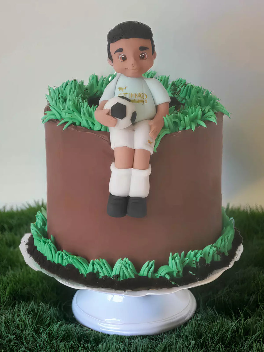 Hand-modelled footballer figurine cake detail