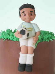 Custom footballer birthday cake with hand-modelled player figurine for London and Surrey delivery