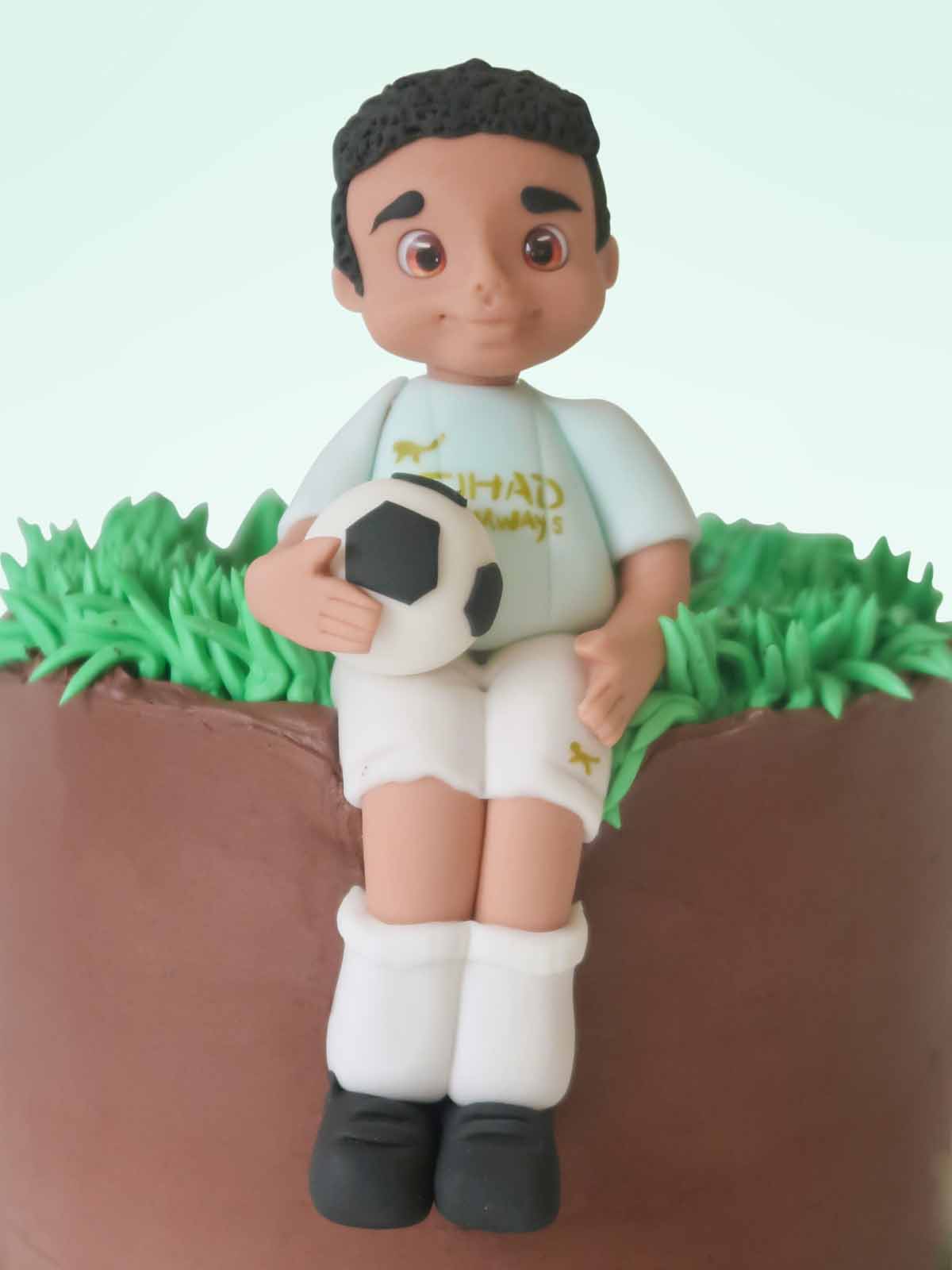 Custom footballer birthday cake with hand-modelled player figurine for London and Surrey delivery