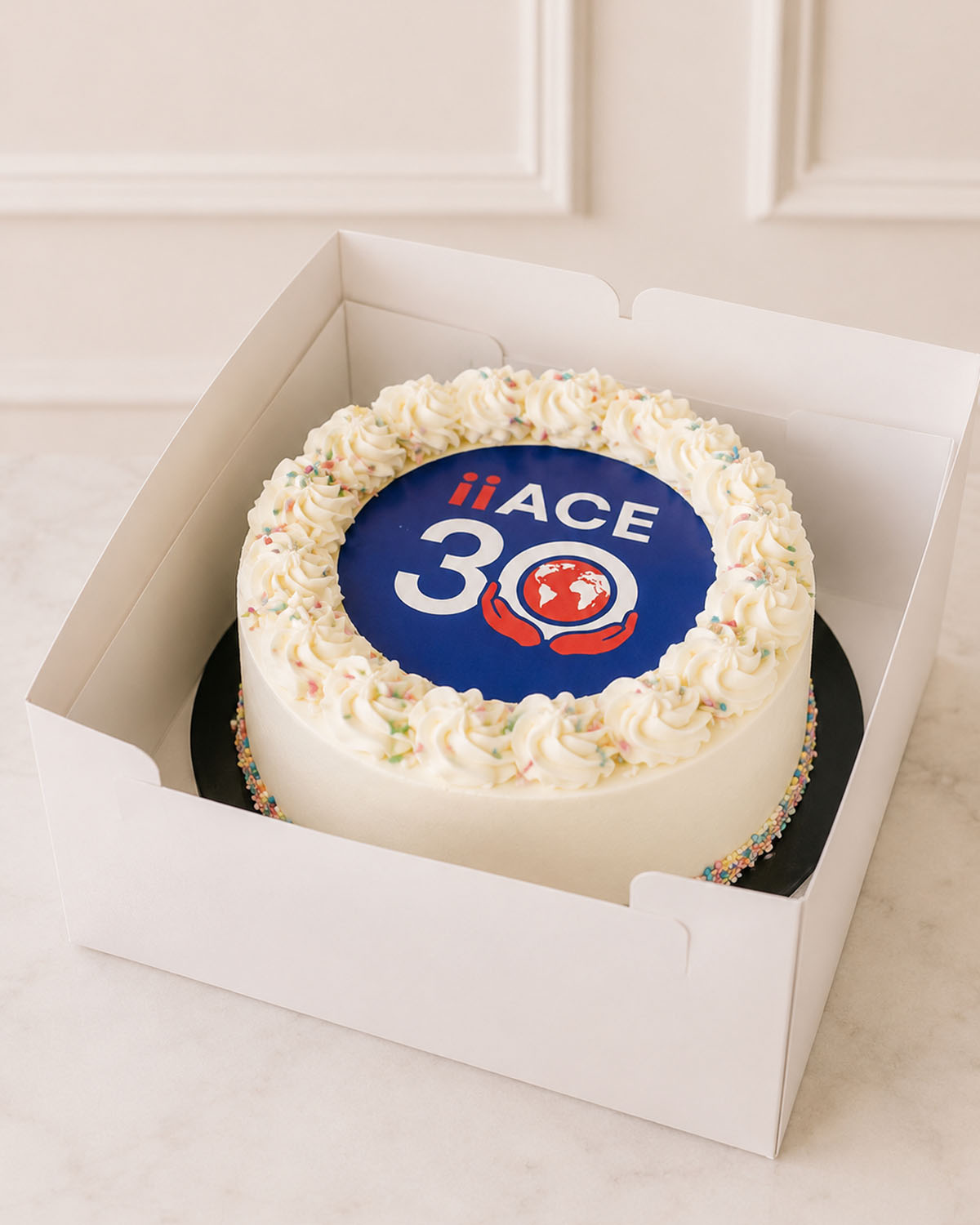 Bespoke corporate event cake with restrained hand-finished detail