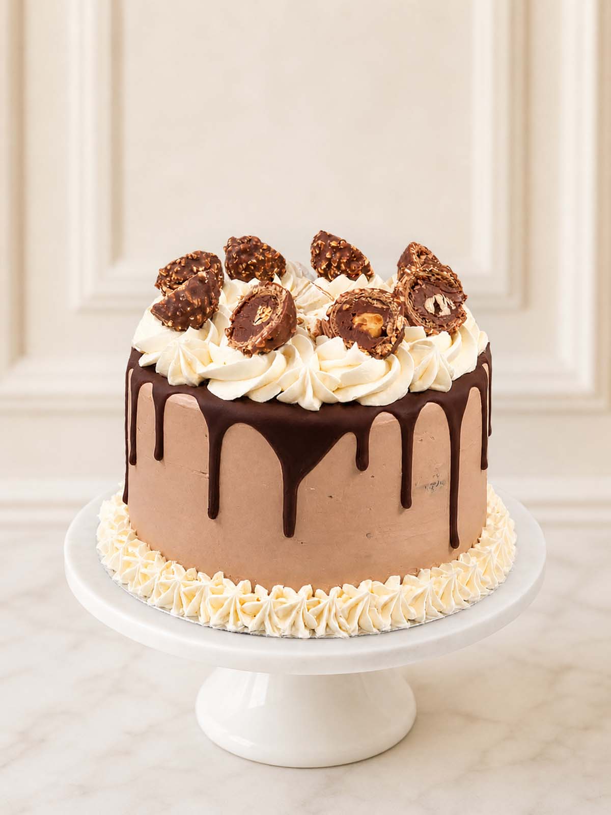 An elegant Nutella celebration cake featuring rich chocolate sponge, Nutella Swiss meringue buttercream, a Belgian chocolate drip, and a crown of Ferrero Rochers, chopped hazelnuts, and pink wafer bits, delivered in London.