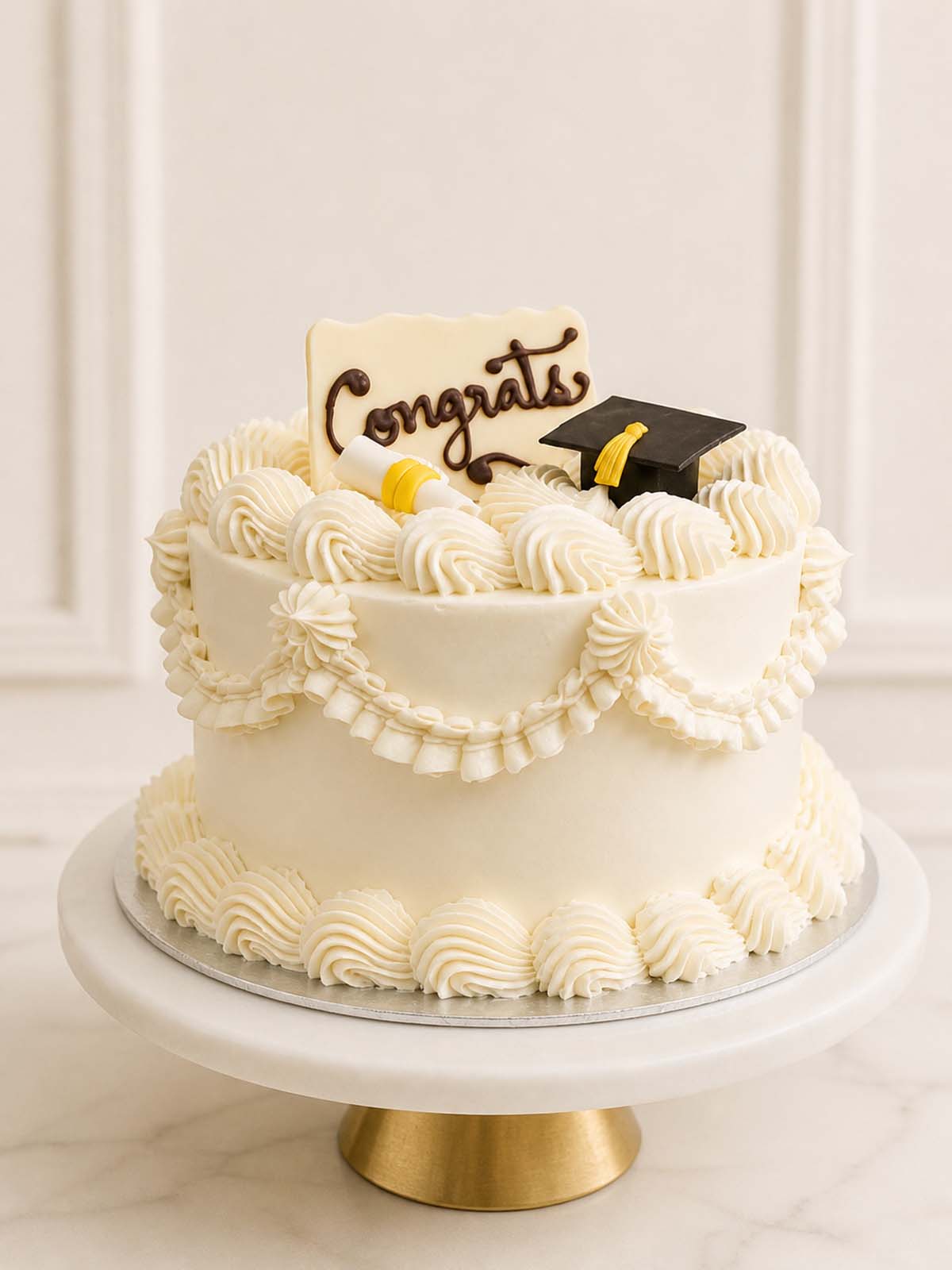 Elegant custom graduation cake featuring vintage retro Lambeth piping, an edible graduation cap, and a scroll cake topper. Available for delivery in London.
