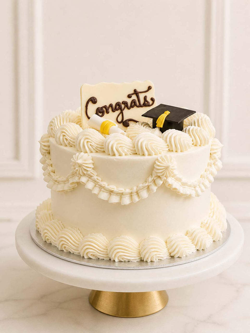 Elegant custom graduation cake featuring vintage retro Lambeth piping, an edible graduation cap, and a scroll cake topper. Available for delivery in London.