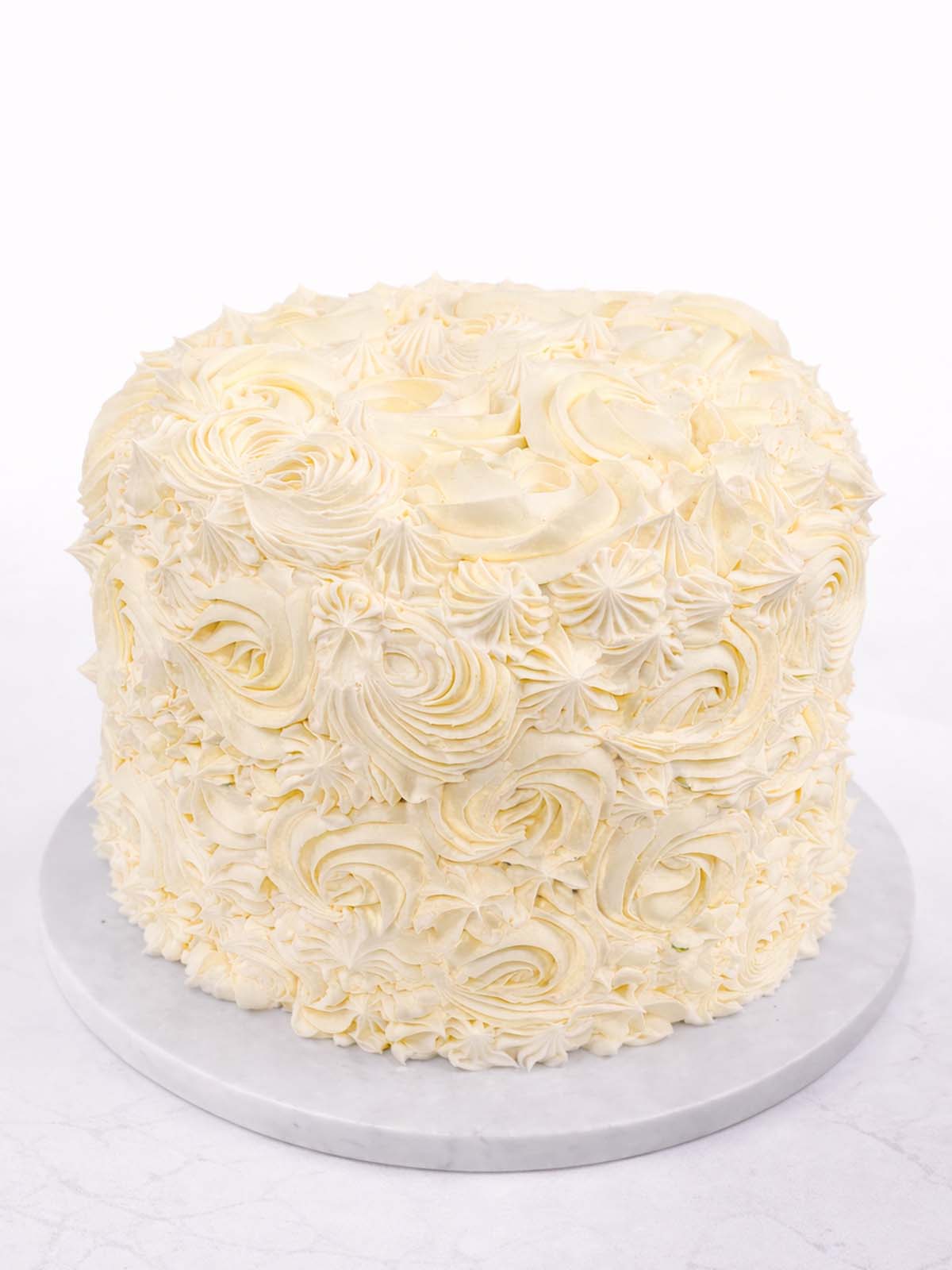 Five-layer vanilla rainbow birthday cake showing the piping from the top, delivered in London