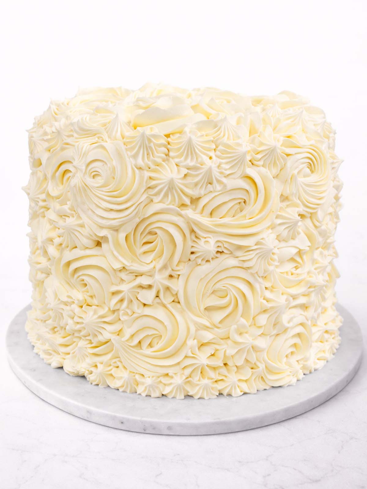 Five-layer vanilla rainbow birthday cake with colourful sponge layers and buttercream, delivered in London