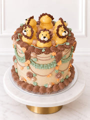 Elevated view of Kitsch Lion Cake with piped lions and buttercream foliage