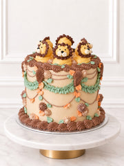 Kitsch Lion Cake with hand-piped buttercream lions and floral piping