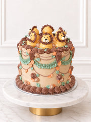 Kitsch Lion Cake with piped lion decorations, foliage and chocolate-brown buttercream