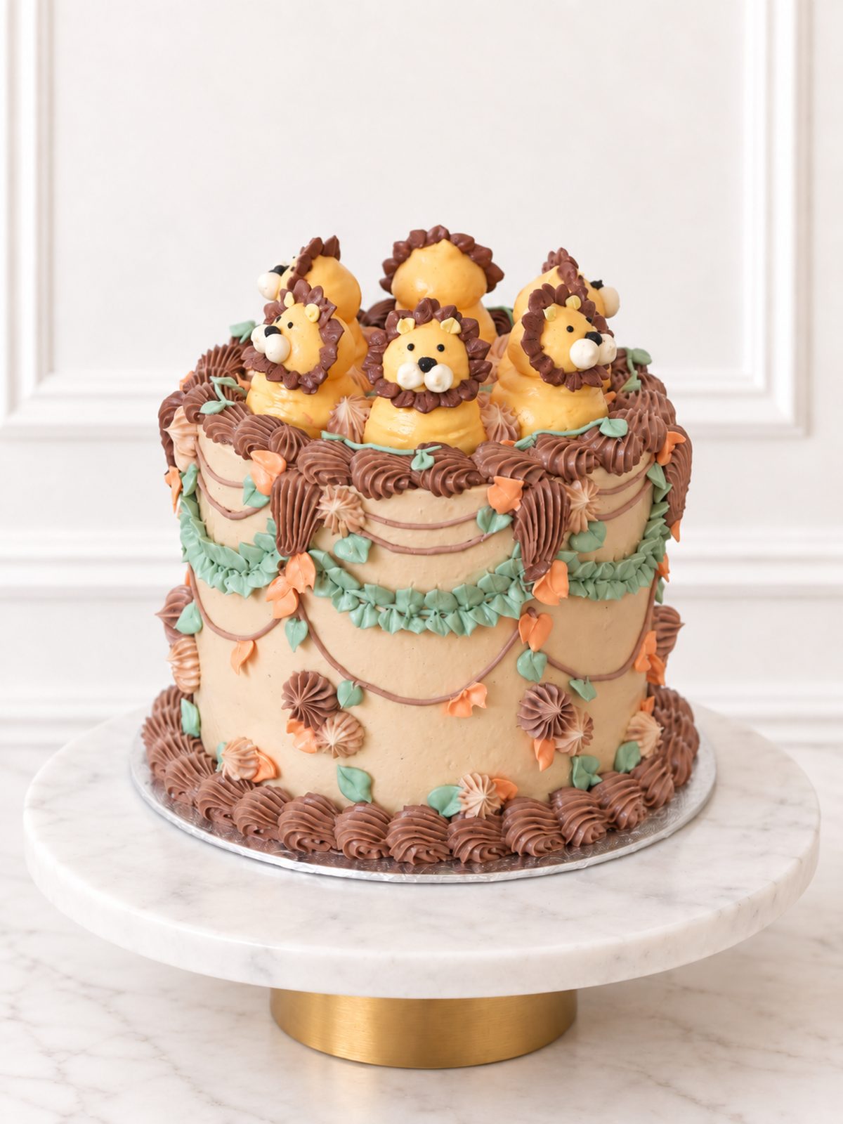 Kitsch Lion Cake with piped lion decorations, foliage and chocolate-brown buttercream