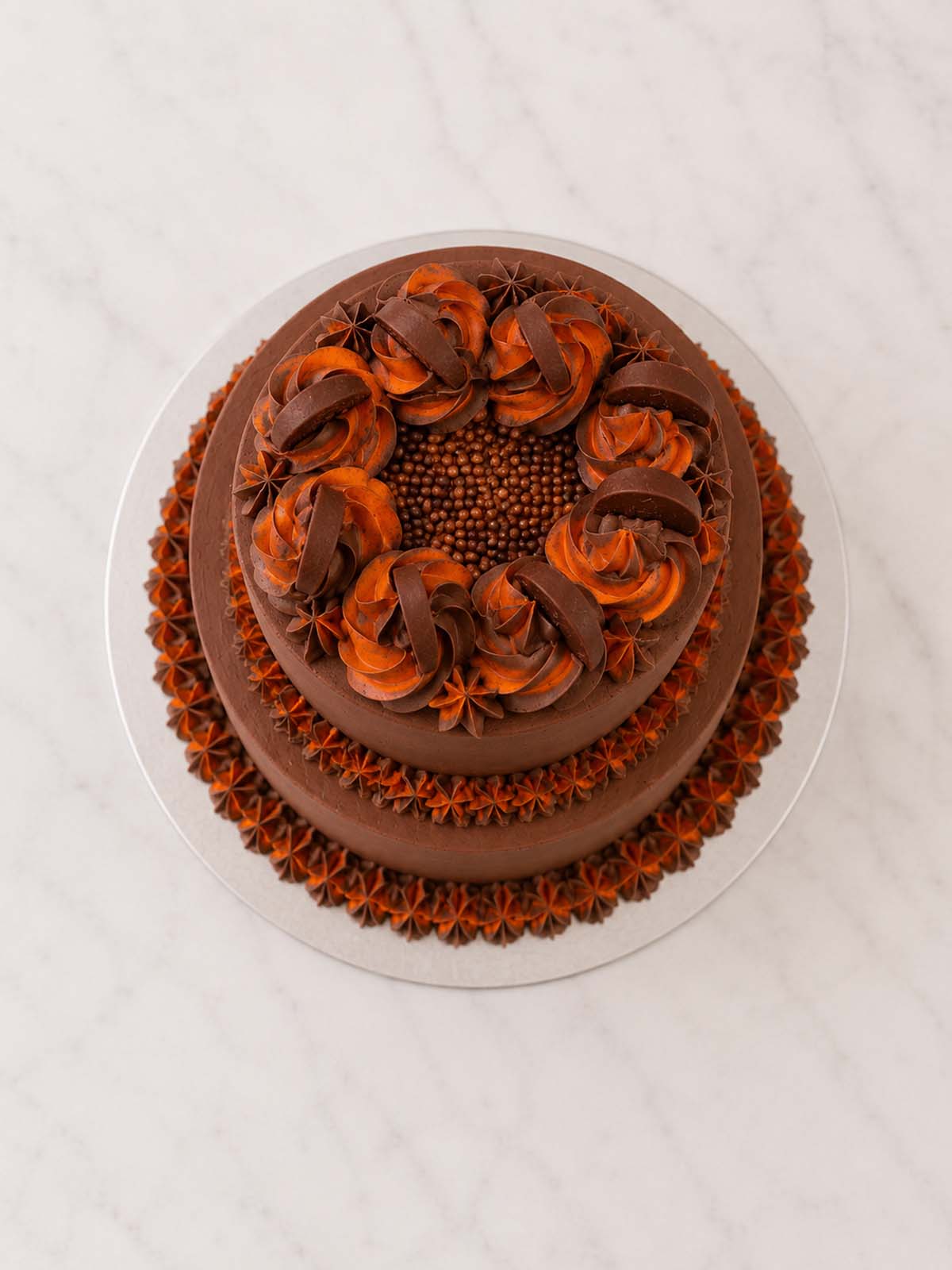 Luxury chocolate orange layer cake topped with orange segments, London & Surrey.