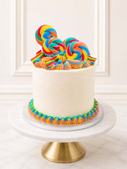 Luxury five-layer rainbow cake with lollipops and sprinkles, London and Surrey.