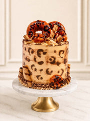 Luxury leopard print cake with salted caramel and doughnuts, London & Surrey.