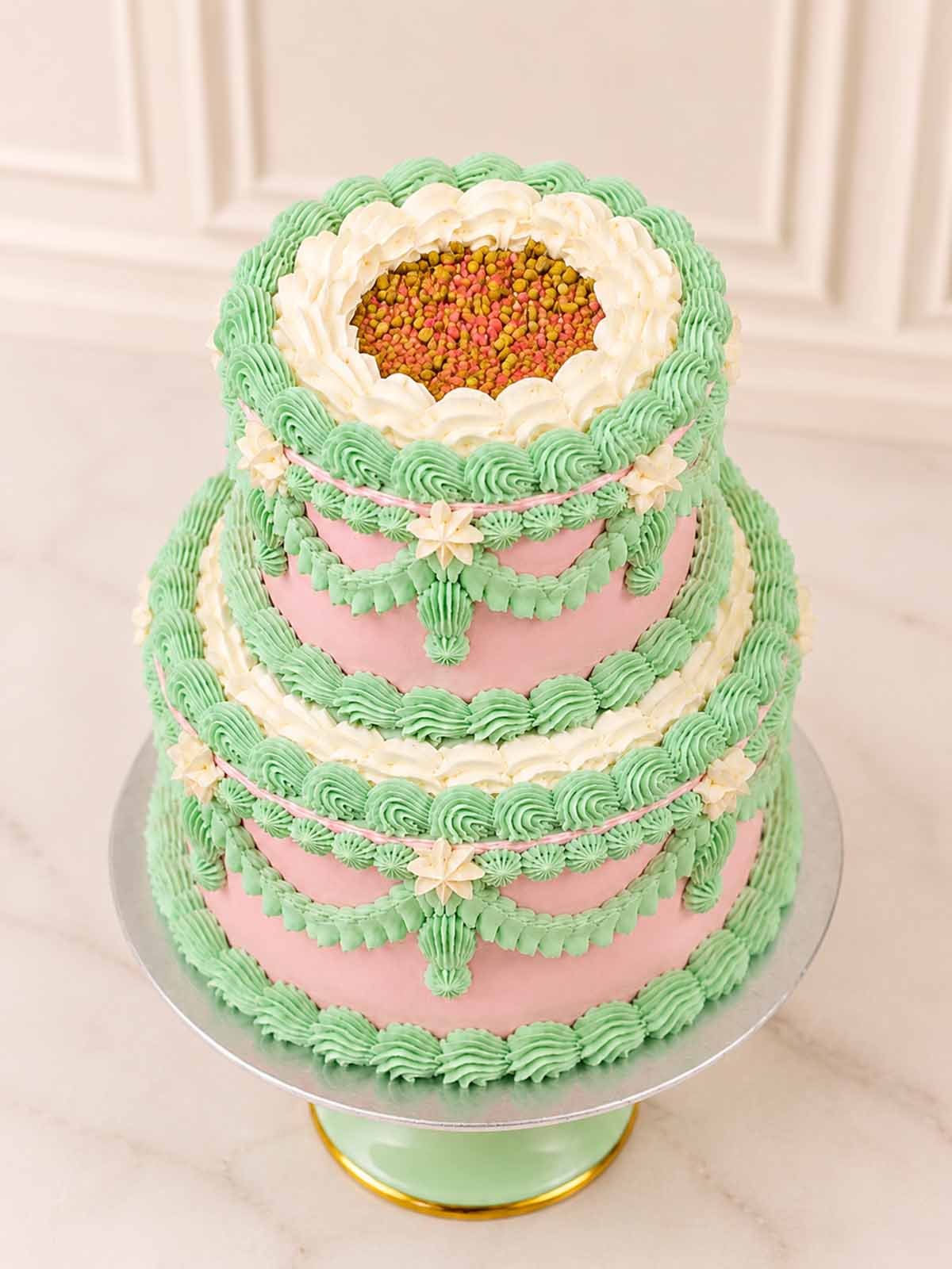 Luxury Parisian-style pistachio and raspberry cake with pink buttercream, London & Surrey.