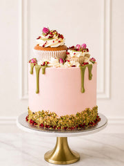 Luxury rose pistachio raspberry cake with rosebuds and cupcakes, London and Surrey.