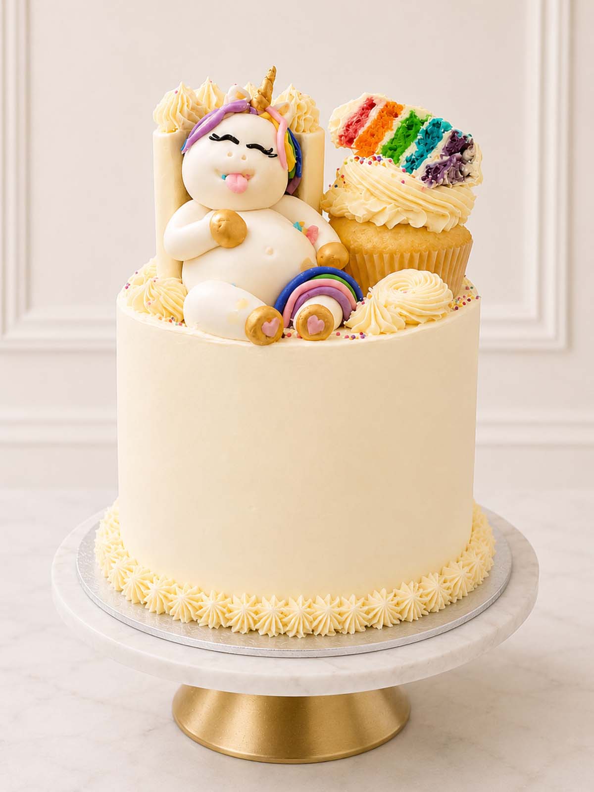 Luxury meta rainbow cake with sleeping unicorn and mini cakes, London & Surrey.