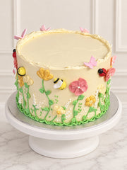 Secret Garden Cake with hand-piped flowers, butterflies, bees and ladybirds