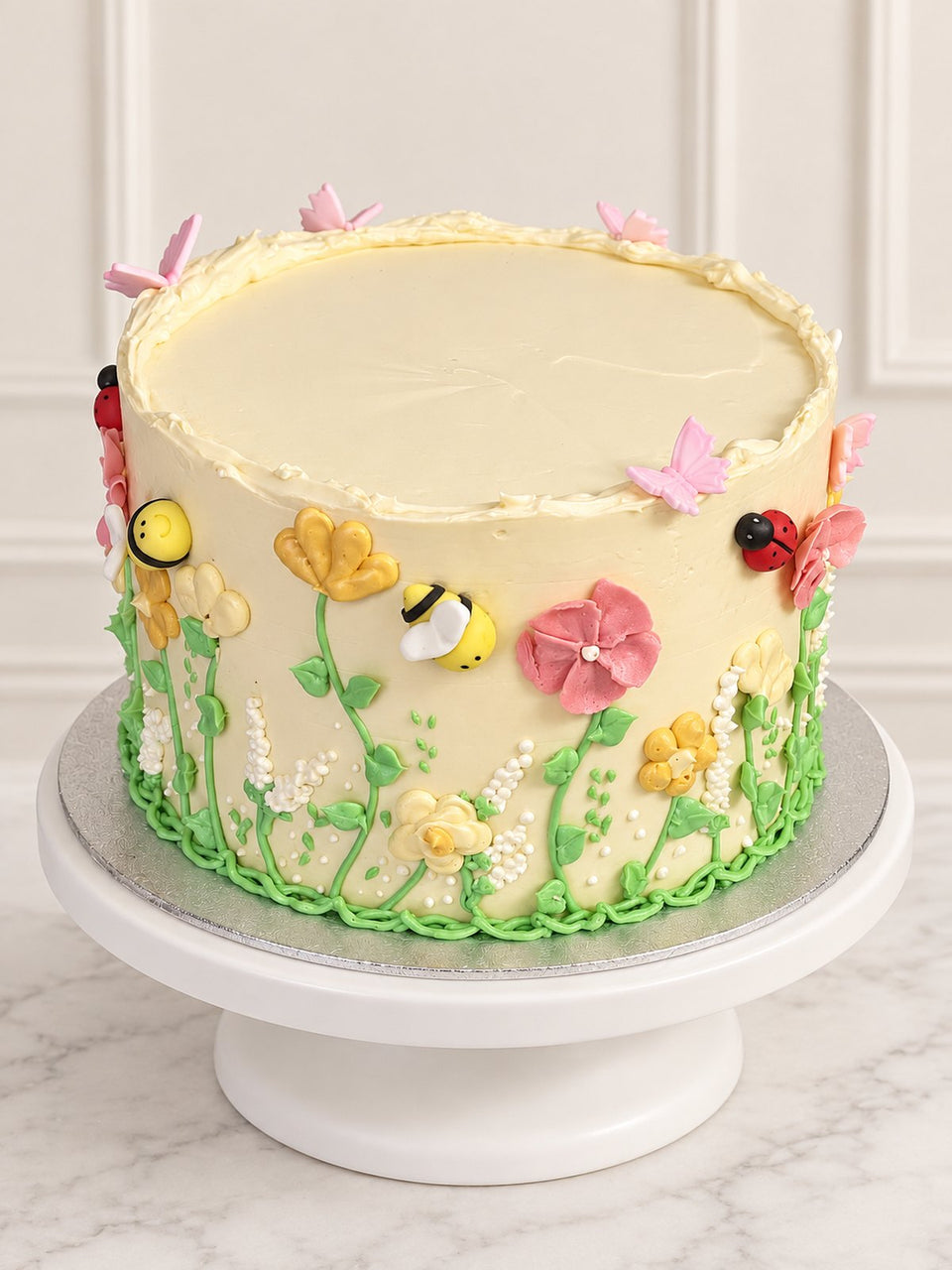 Secret Garden Cake with hand-piped flowers, butterflies, bees and ladybirds