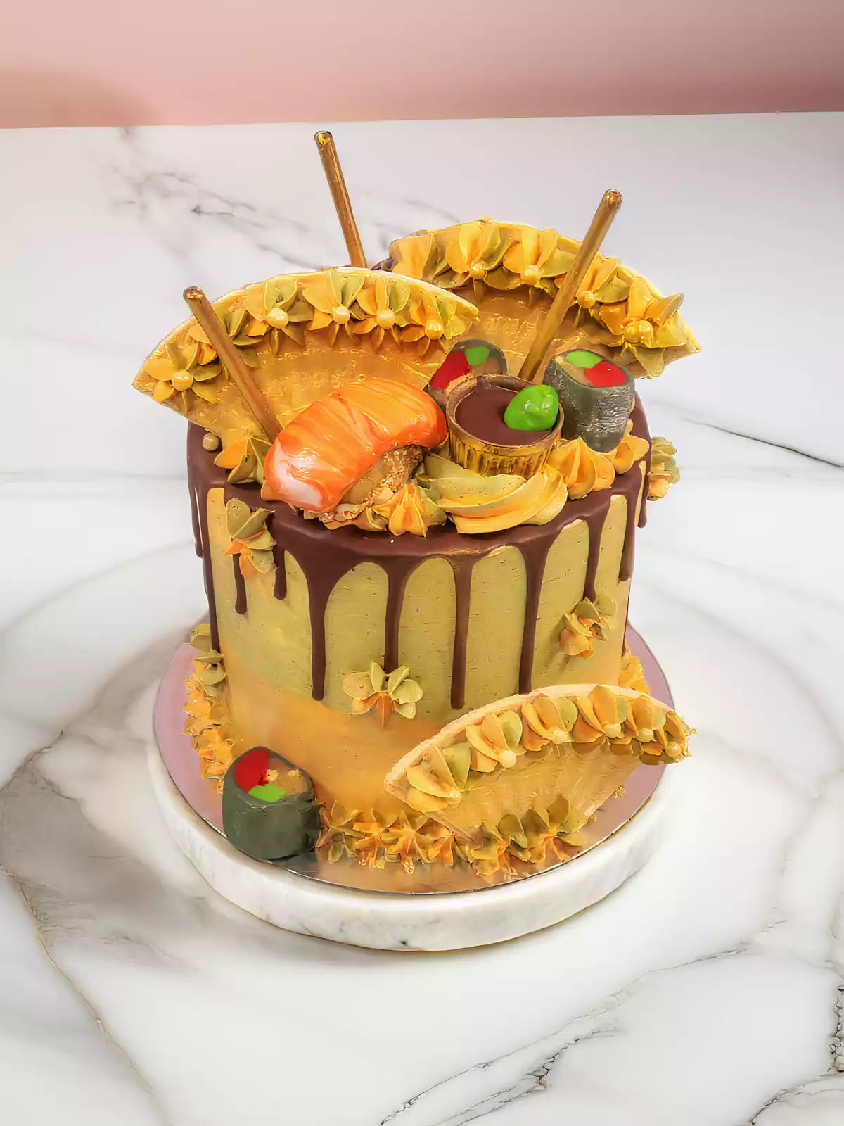 Side view of sushi cake with matcha buttercream, chocolate drip and biscuit sticks.