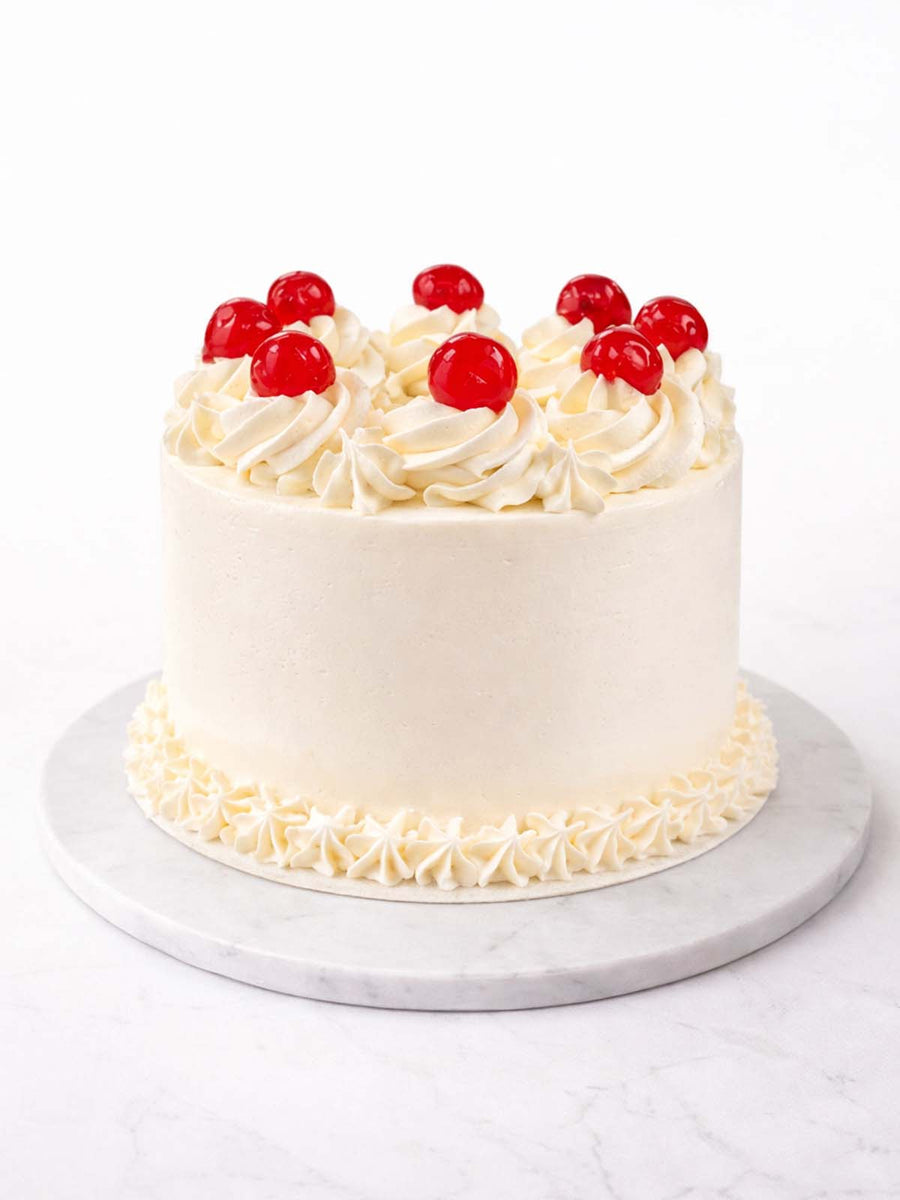 Vanilla party birthday cake with smooth buttercream and celebratory decoration
