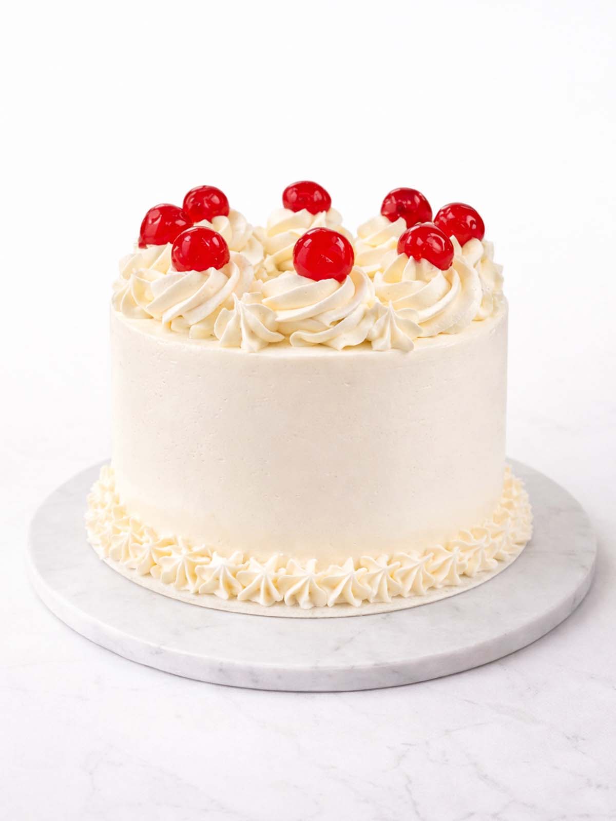 Vanilla party birthday cake with smooth buttercream and celebratory decoration, delivered in London